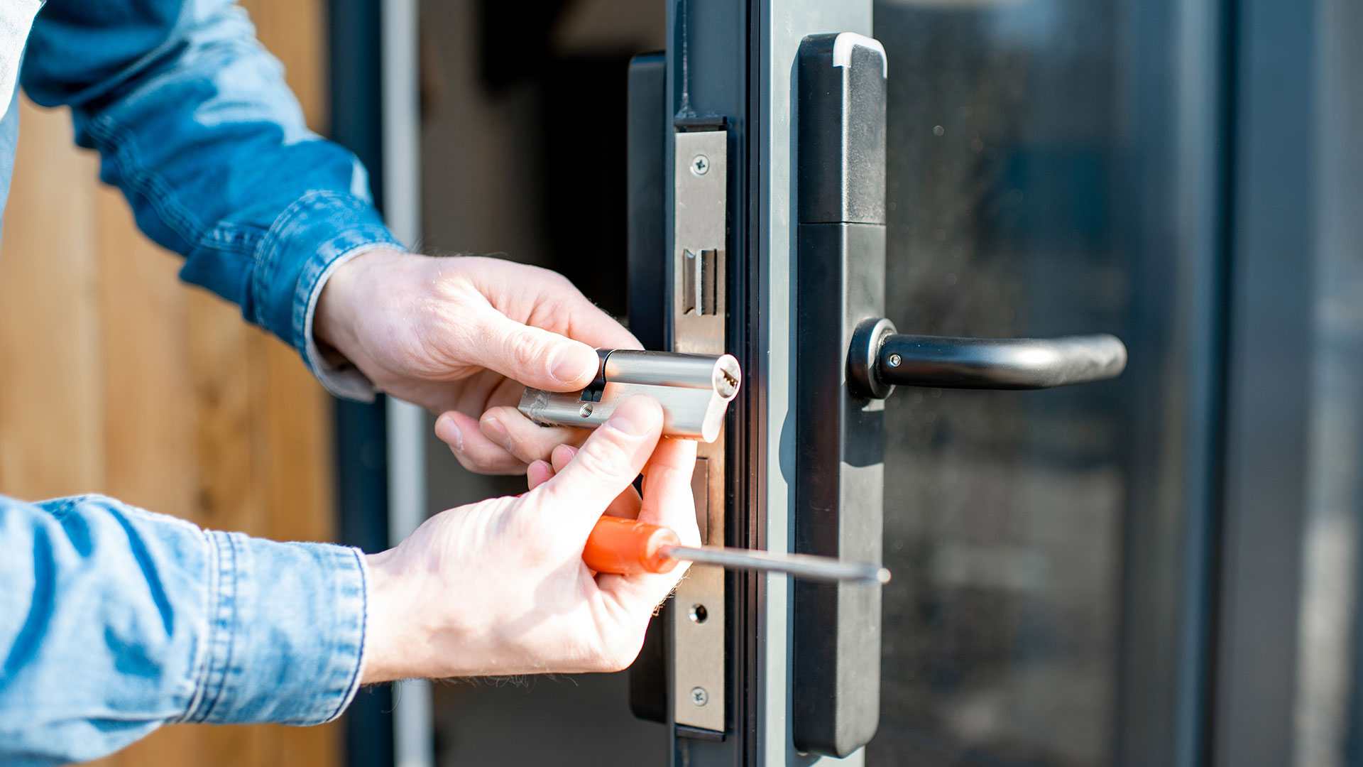 Man changing core of a door lock