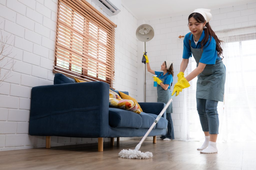 Professional cleaners cleaning the living room for a move-in