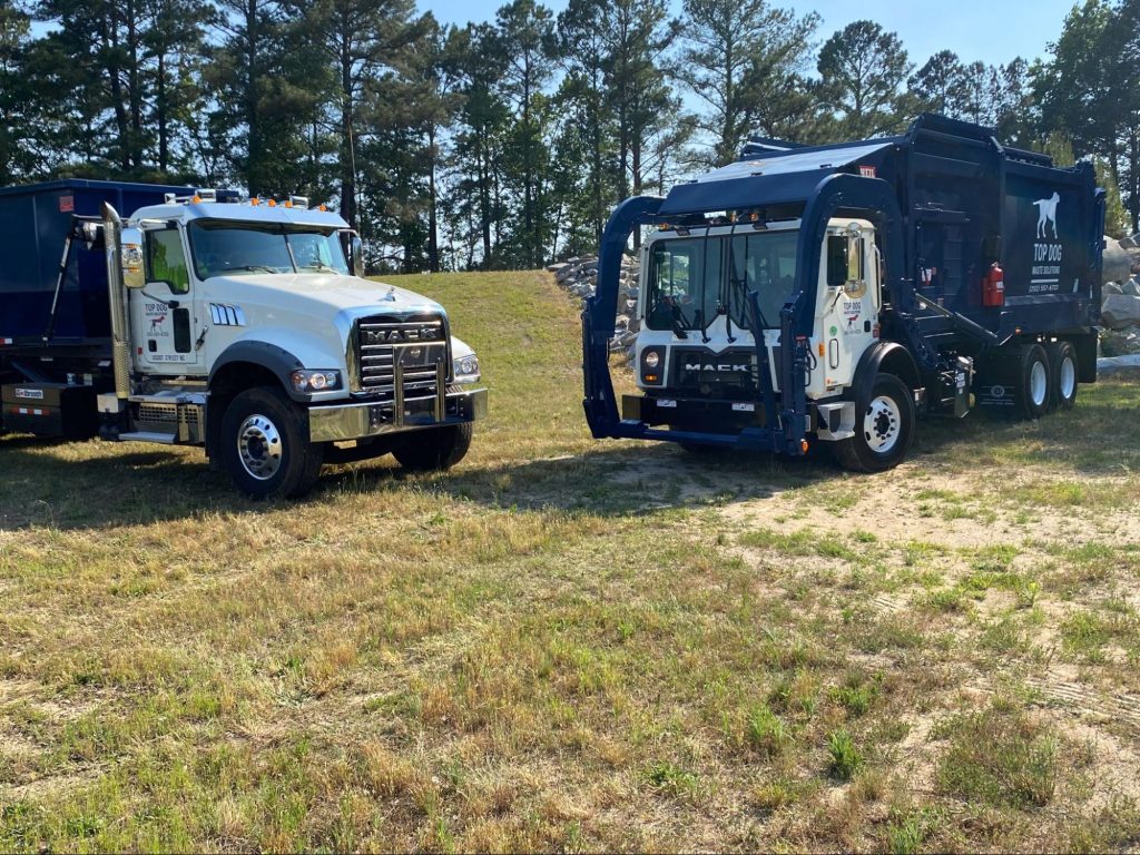 A garbage collector disposes trash bags to the truck.
